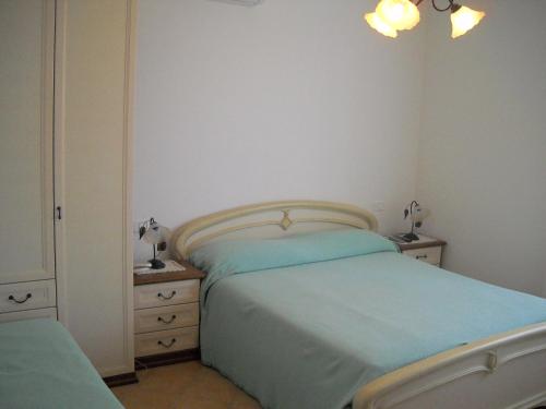a small bedroom with a bed and a dresser at Villa Malandrino Guest House in Agropoli
