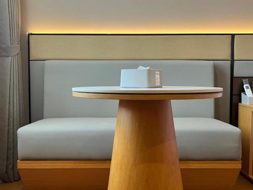 a table with a book sitting on top of it at U&ME HOTEL Segamat Sdn Bhd in Segamat