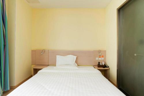 a bedroom with a large white bed in a room at 7 Days Inn Suzhou Wangting Pearl Commercial Plaza in Suzhou