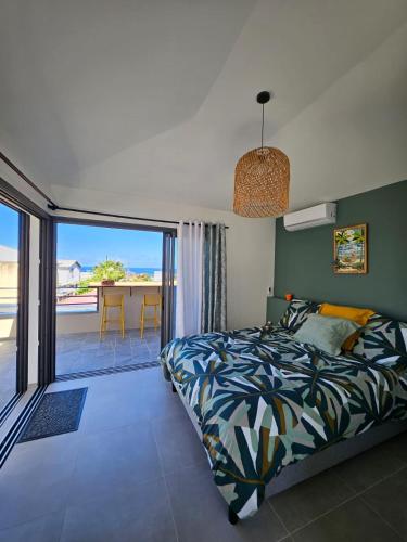 a bedroom with a bed and a view of the ocean at joly brise in Saint-Pierre