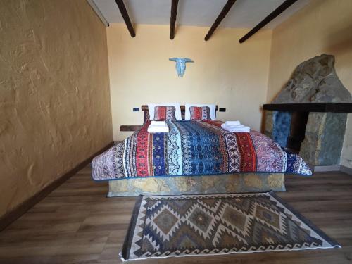 a bedroom with a bed with colorful blankets at Alturas del Montgo in Denia