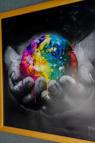 a painting of a hand holding a colorful object at Appartement Cosy - Résidence avec Parc et Piscine in Marans