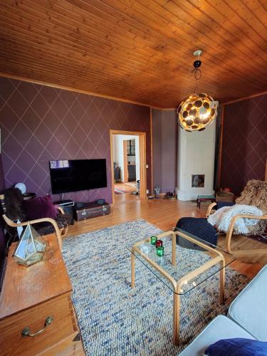 a living room with a couch and a table at Perfect spot to enjoy in Pargas