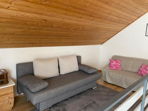 a living room with a couch and a chair at Johanna Balatoni Ház in Balatonfenyves