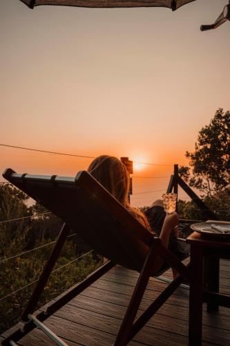 a little girl sitting in a hammock watching the sunset at The Ocean Dome - Misty Mountain Reserve in Thornham