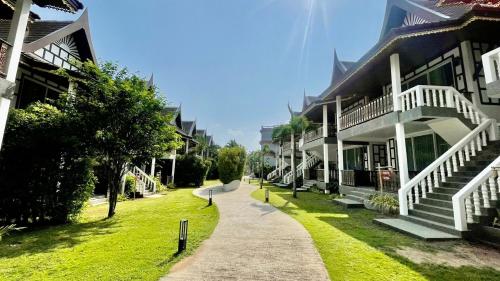 a walkway in front of a building at Aura Samui Best Beach Hotel - SHA Plus in Lamai