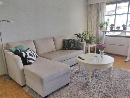 a living room with a couch and a coffee table at Two-room apartment with sauna in the Old Town in Savonlinna