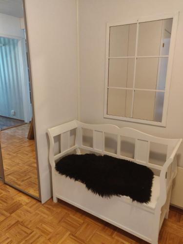 a room with a mirror and a white couch with a black blanket at Two-room apartment with sauna in the Old Town in Savonlinna