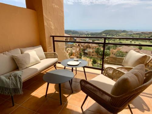 a living room with a couch and chairs on a balcony at M&M La Cala Suite in La Cala de Mijas