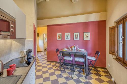 a kitchen with a table and chairs in a room at Romantic Apartment In Chianti Classico - Happy Rentals in Castelnuovo Berardenga