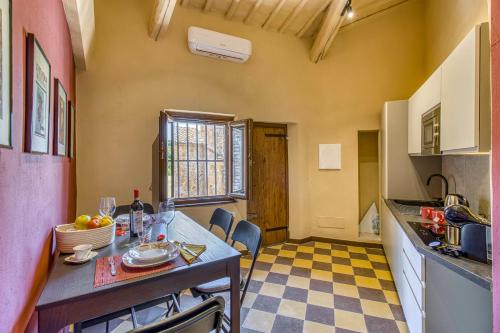 a kitchen with a table and a counter top at Romantic Apartment In Chianti Classico - Happy Rentals in Castelnuovo Berardenga