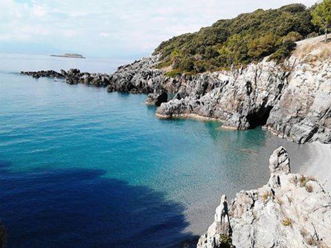 a large body of water next to a rocky beach at Hotel Club San Diego in Maratea