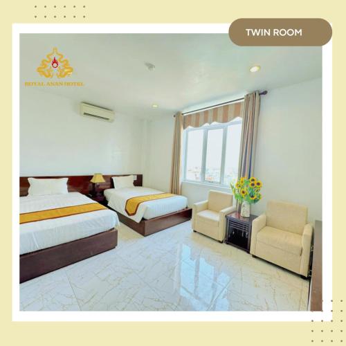 a hotel room with two beds and two chairs at Royal ANAN Hotel in Ninh Binh
