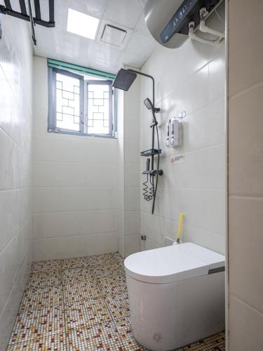 a white bathroom with a tub and a sink at Guilin Tranquil Peaks Retreat by Reed Flute Cave in Guilin