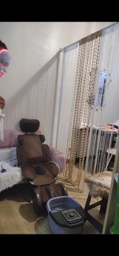 a living room with a chair and a couch at Condotel Near NAIA - massage chair footspa, dance revo, small pet allowed in Manila