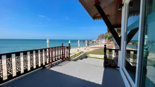 a balcony of a house with a view of the beach at Aura Samui Best Beach Hotel - SHA Plus in Lamai