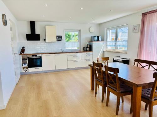 a kitchen and dining room with a table and chairs at Atemberaubender Ausblick mit Premium-Wanderwegen vor der Haustür in Albstadt