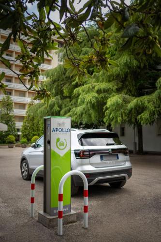 a car parked in a parking lot with aania gas pump at Hotel Apollo Terme in Montegrotto Terme