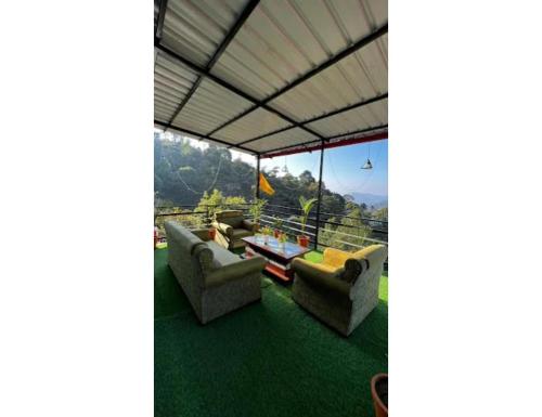 a view from the roof of a house with chairs and a table at Sumangalam Homestay सुमंगलम होमस्टे in Devaprayāg