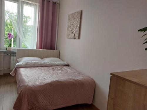 Posteľ alebo postele v izbe v ubytovaní Apartament przy Jeziorku Magistrackim