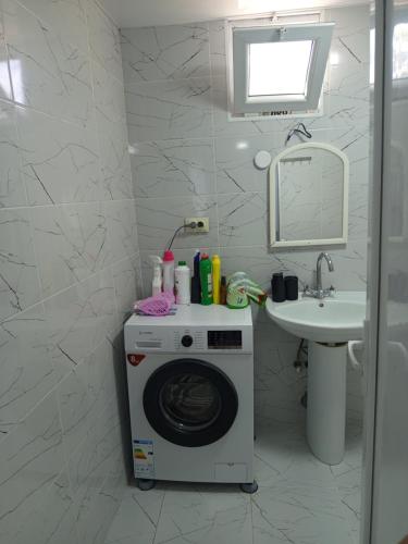 a washing machine in a bathroom with a sink at Belas House With Terrace in Kutaisi