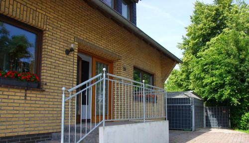 a brick house with a gate in front of it at Ferienwohnung Wiesenblick in Geldern