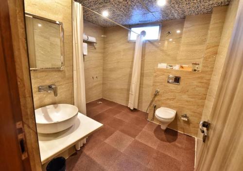 a bathroom with a sink and a toilet at Foxoso Fiori Hotel in Jaipur