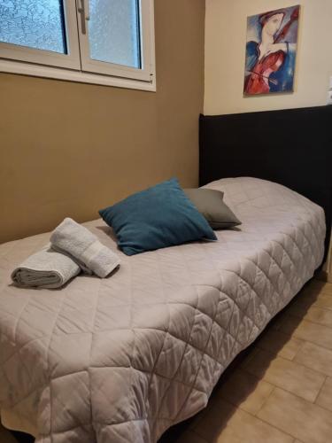 a bed with two pillows on it in a bedroom at Leonidas Private Apartment in Sparta in Sparti