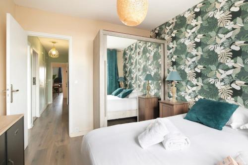 - une chambre avec un lit blanc et un papier peint floral dans l'établissement Gorgeous apartment Near Paris - 5P, à Clichy