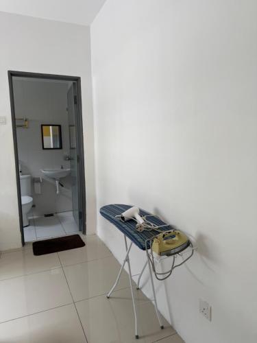 a bathroom with a table with a sink and a mirror at KH Water Park Manhattan Condo Ipoh Homestay in Kampong Pinji