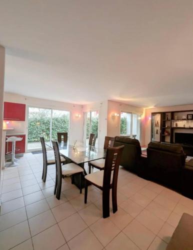 un salon avec une table et des chaises de salle à manger dans l'établissement Maison 2 Chambres, à Mimizan-Plage