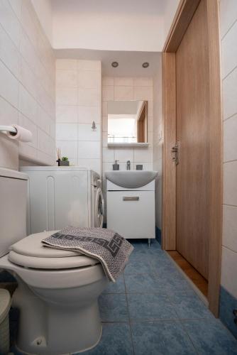 a bathroom with a toilet and a sink at Filio's House in Samothraki