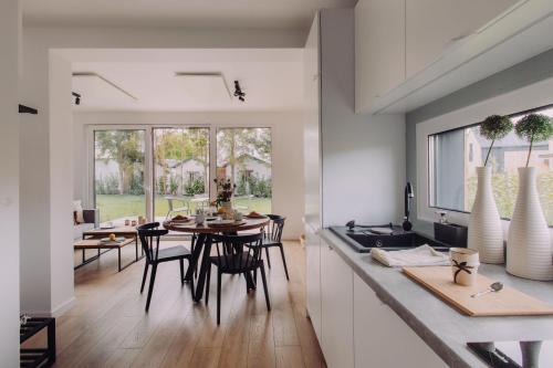 a kitchen and dining room with a table and chairs at BialogoraChill11C in Białogóra
