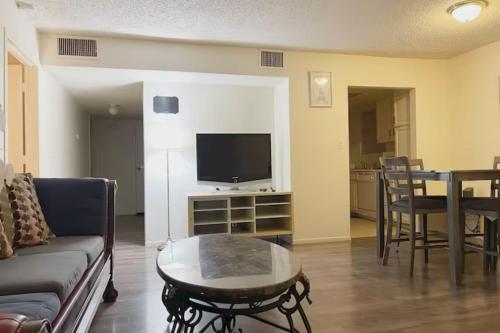 a living room with a couch and a table with a tv at 2 Or 3 Bedroom Condo Walk To Mgm Casino And Strip in Las Vegas
