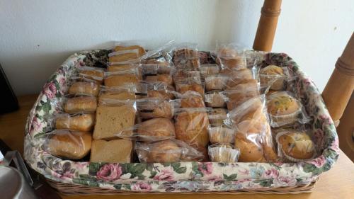 a basket of sandwiches in plastic bags on a table at Il Giardino dell'Eden in Caprile