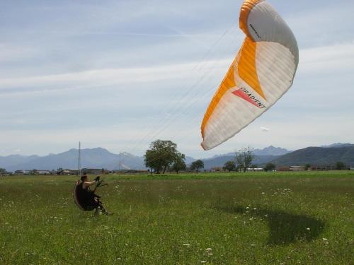 un uomo che fa volare un aquilone in un campo di Locanda Dl'Angel a Villar San Costanzo