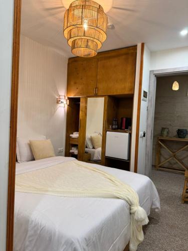 a bedroom with two beds and a chandelier at Palm Tbilisi Boutique Hotel in Tbilisi City