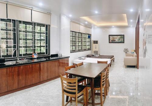 a kitchen with a table and a dining room at Pham'sHomestay 