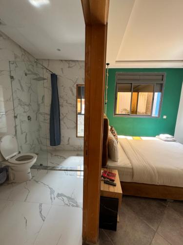 a bathroom with a bed and a toilet in a room at Playa Surf House in Tamraght Ouzdar