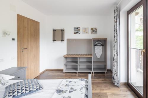 a bedroom with a bed and a desk at PENTA by Alfinio in Sinaia
