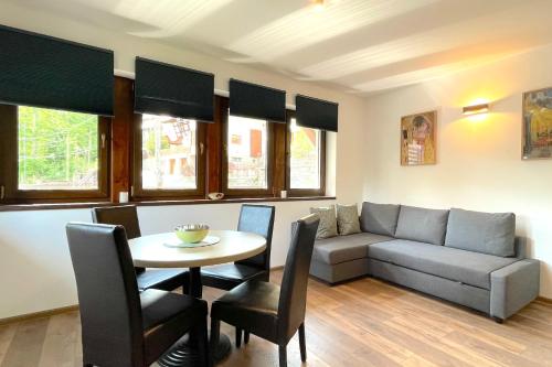 a living room with a couch and a table at PENTA by Alfinio in Sinaia