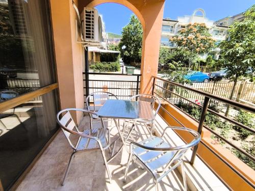 a balcony with a table and chairs on it at Dom-El Real Apartments 4 - Sveti Vlas in Sveti Vlas