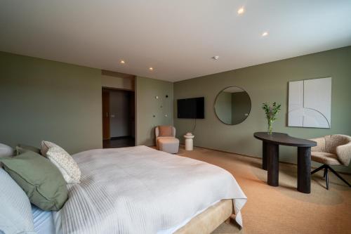 a bedroom with a bed and a table and a tv at Hotel Vest Mar in Ólafsvík