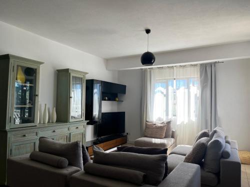 a living room with a couch and a tv at Fortuna Beach in Flic-en-Flac
