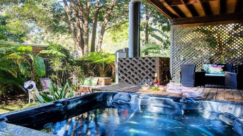 een zwembad midden in een tuin bij The Treehouse -Pet Friendly, Heated Spa in Pearl Beach