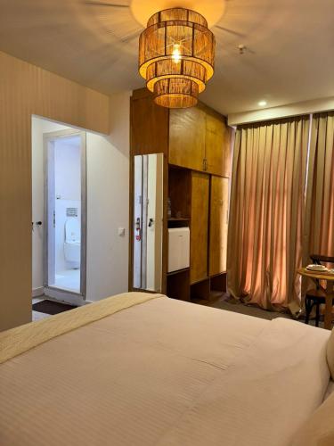 a bedroom with a bed and a bathroom with a toilet at Palm Tbilisi Boutique Hotel in Tbilisi City