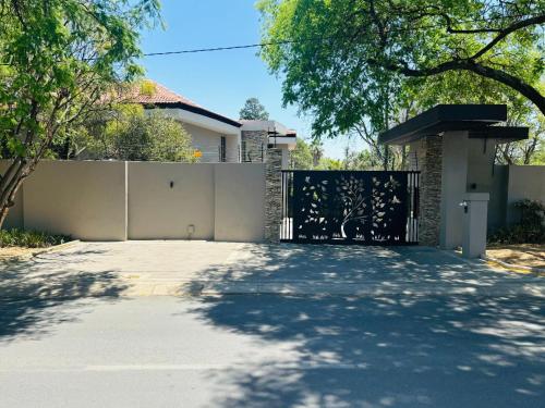 a driveway in front of a house with a gate at The Symbol in Fourways