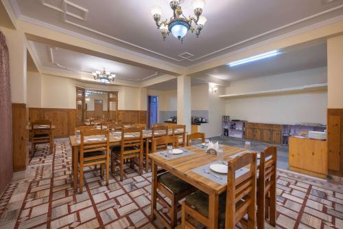 a large dining room with wooden tables and chairs at Echor - The Alpine Crest in Kalpa
