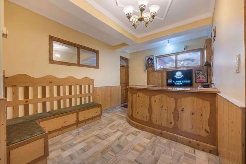 a large room with wooden paneling and a tv at Echor - The Alpine Crest in Kalpa