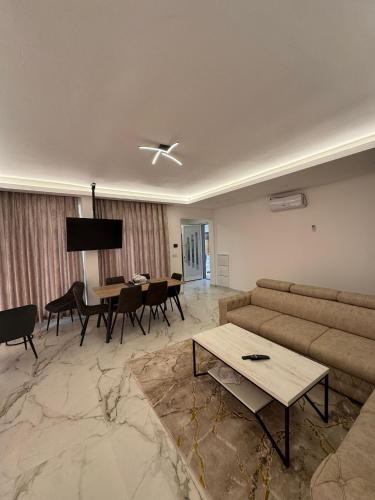 a living room with a couch and a table at Crater H in Kukrike